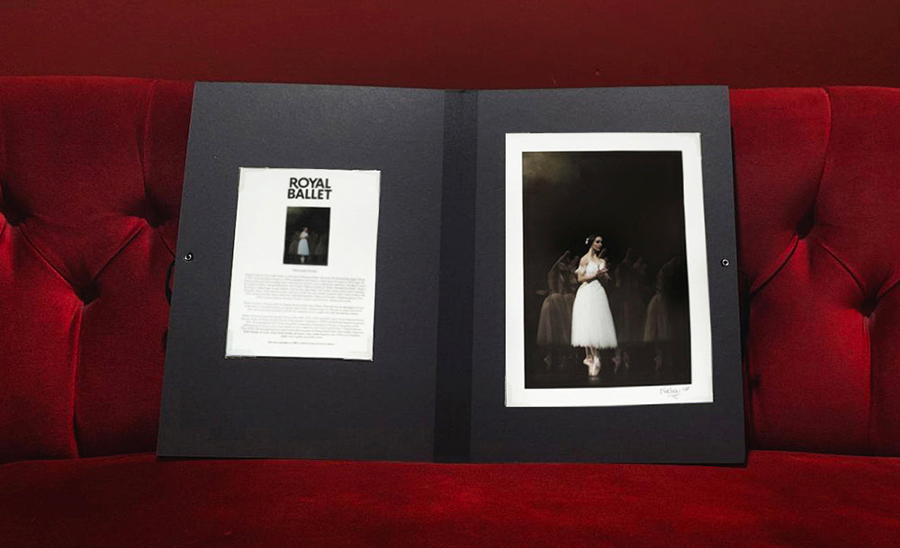 Marianela Nunez Signed Portfolio on a red velvet couch