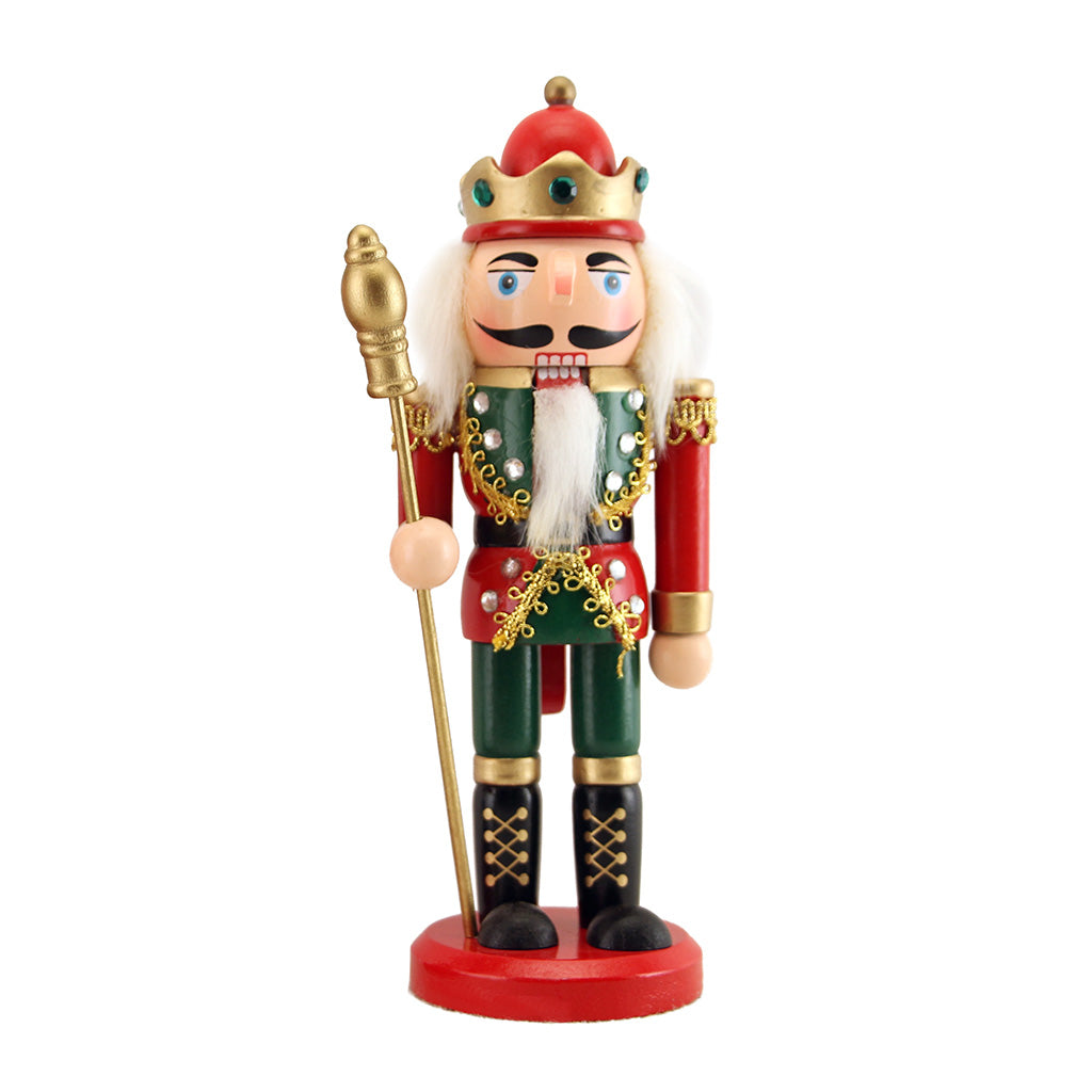 Colourful nutcracker figurine with a crown and holding a staff on a white background