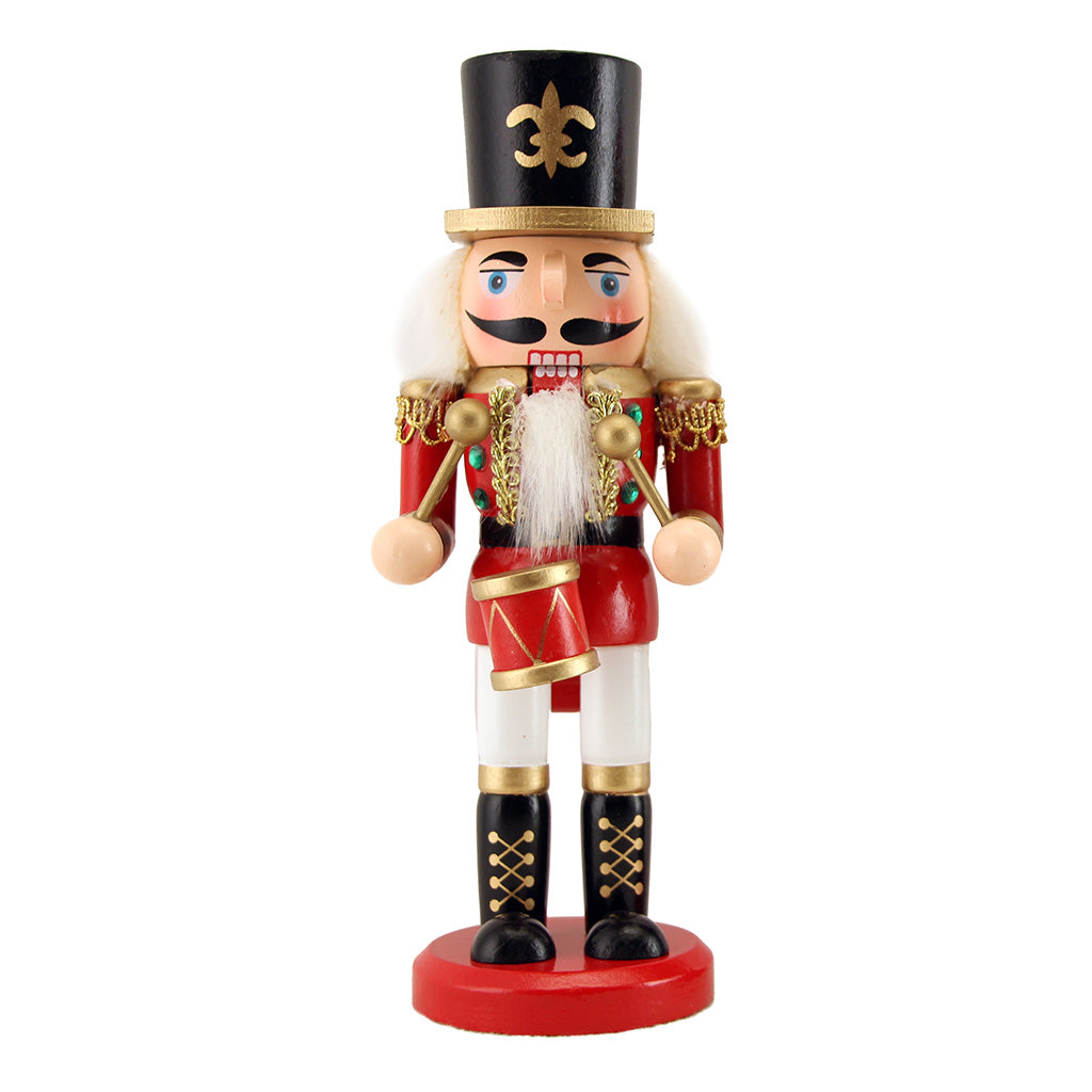 Nutcracker figurine with red uniform and black hat on a white background