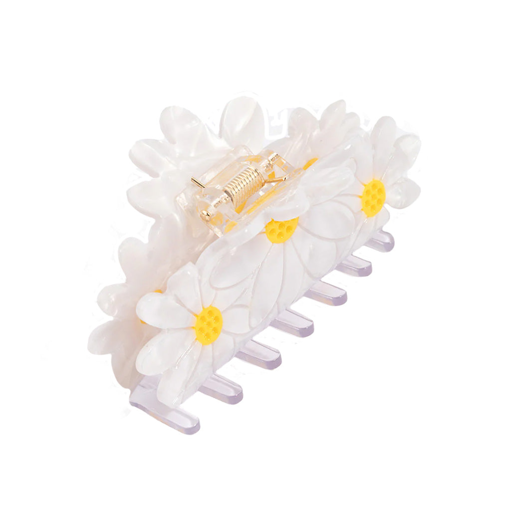 Set of three white daisies flower hair clips with yellow centres on a white background