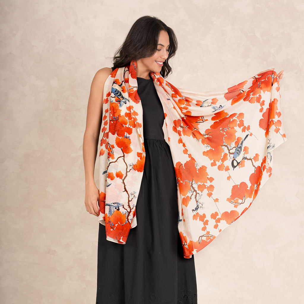 model wearing Acer Red Scarf in black dress in front of cream wall