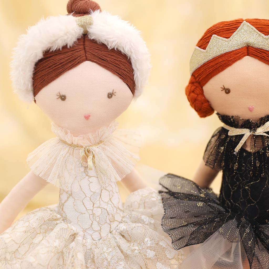 White Swan Doll in a white dress with a feather headband on a white background