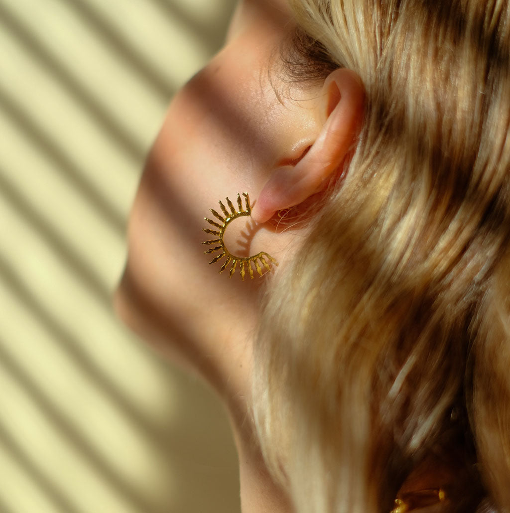 Aylin Hoop Earrings on model with shadows from blinds