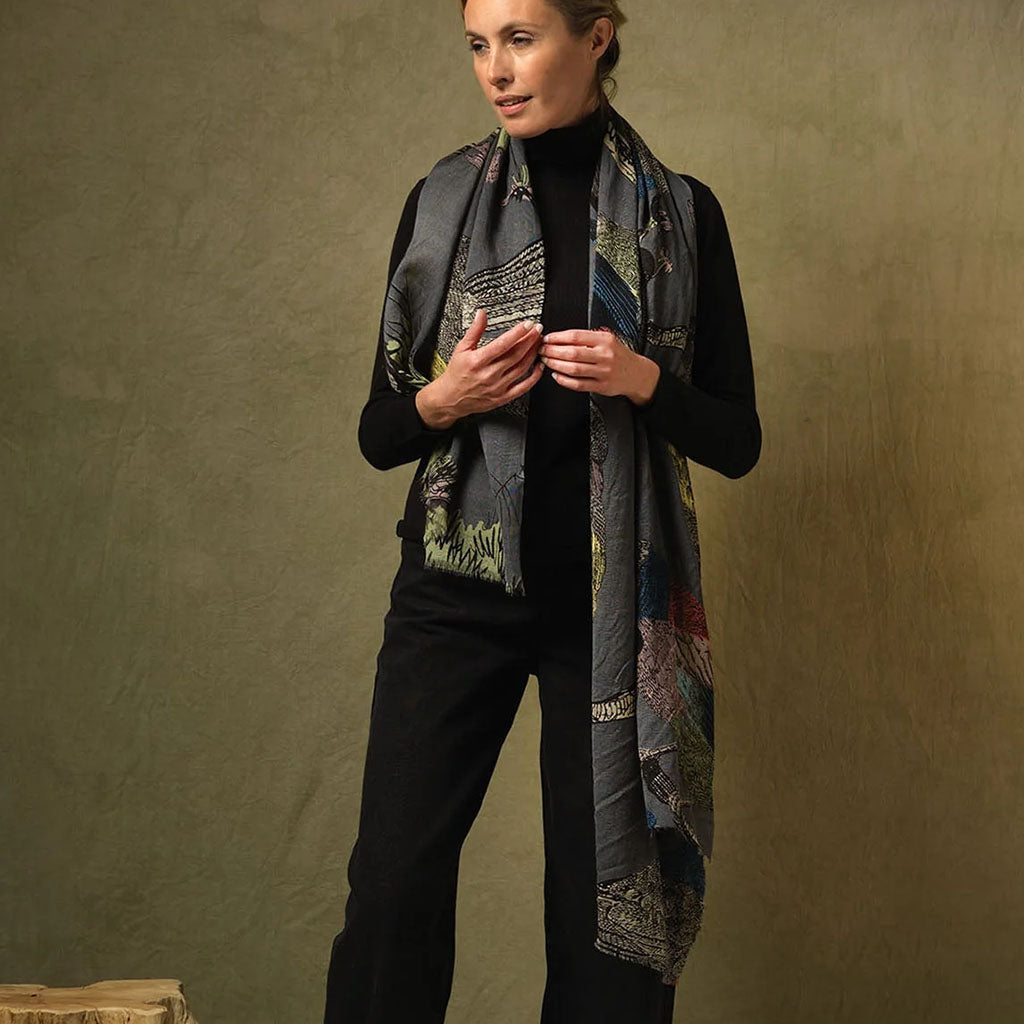 Woman wearing a Bird patterned scarf against a brown background