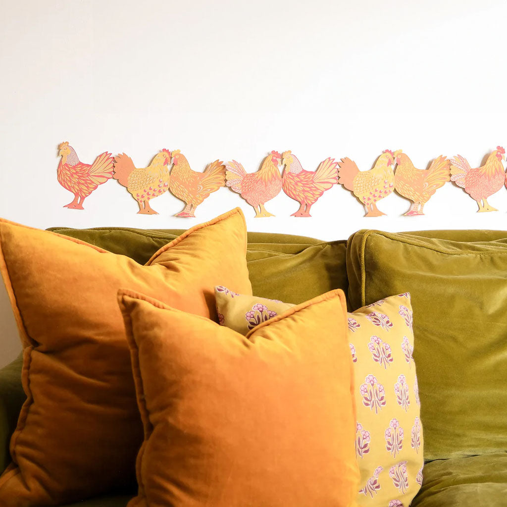 Pattern paper garland of colourful chickens on a white background