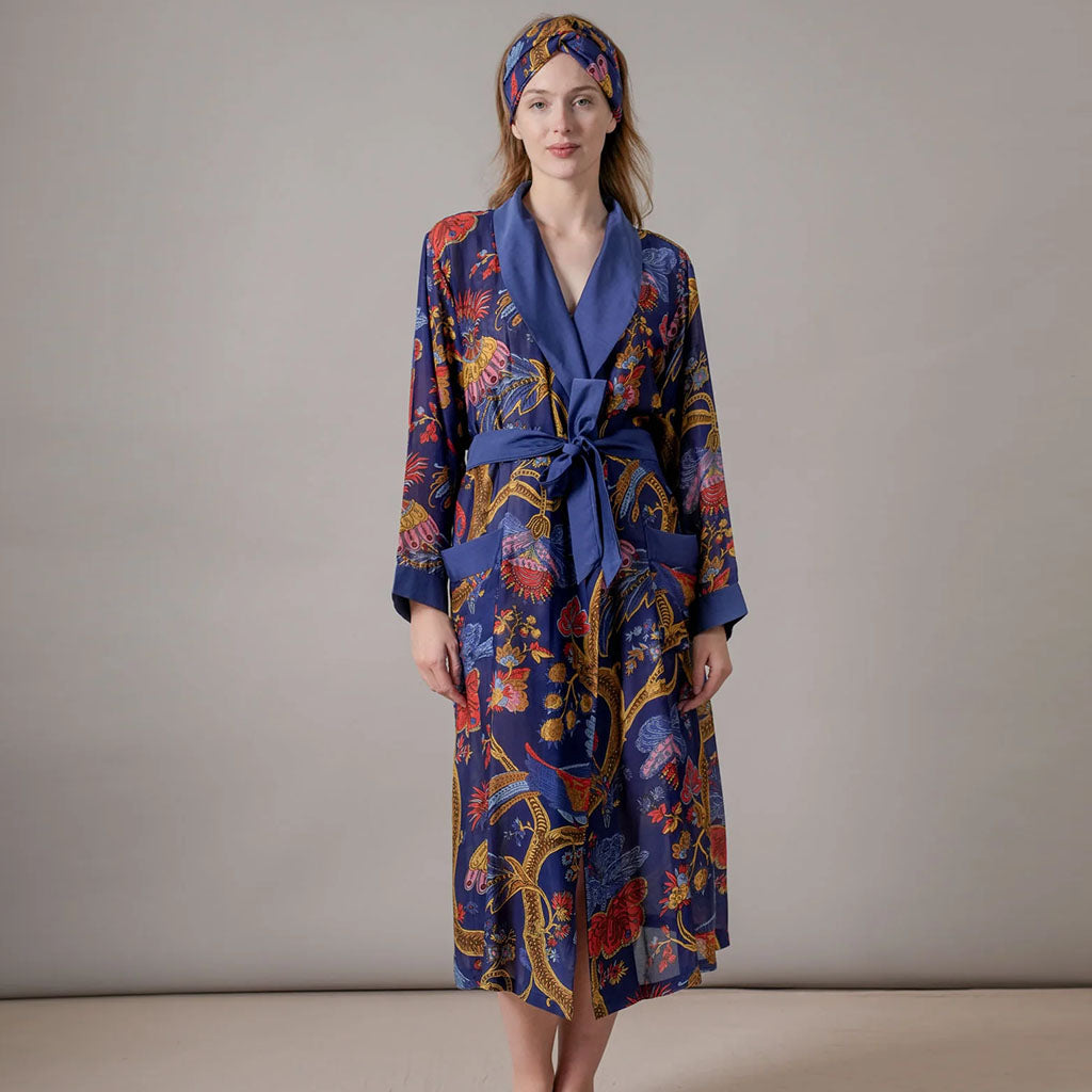 Colourful gown with peacock pattern on a white background