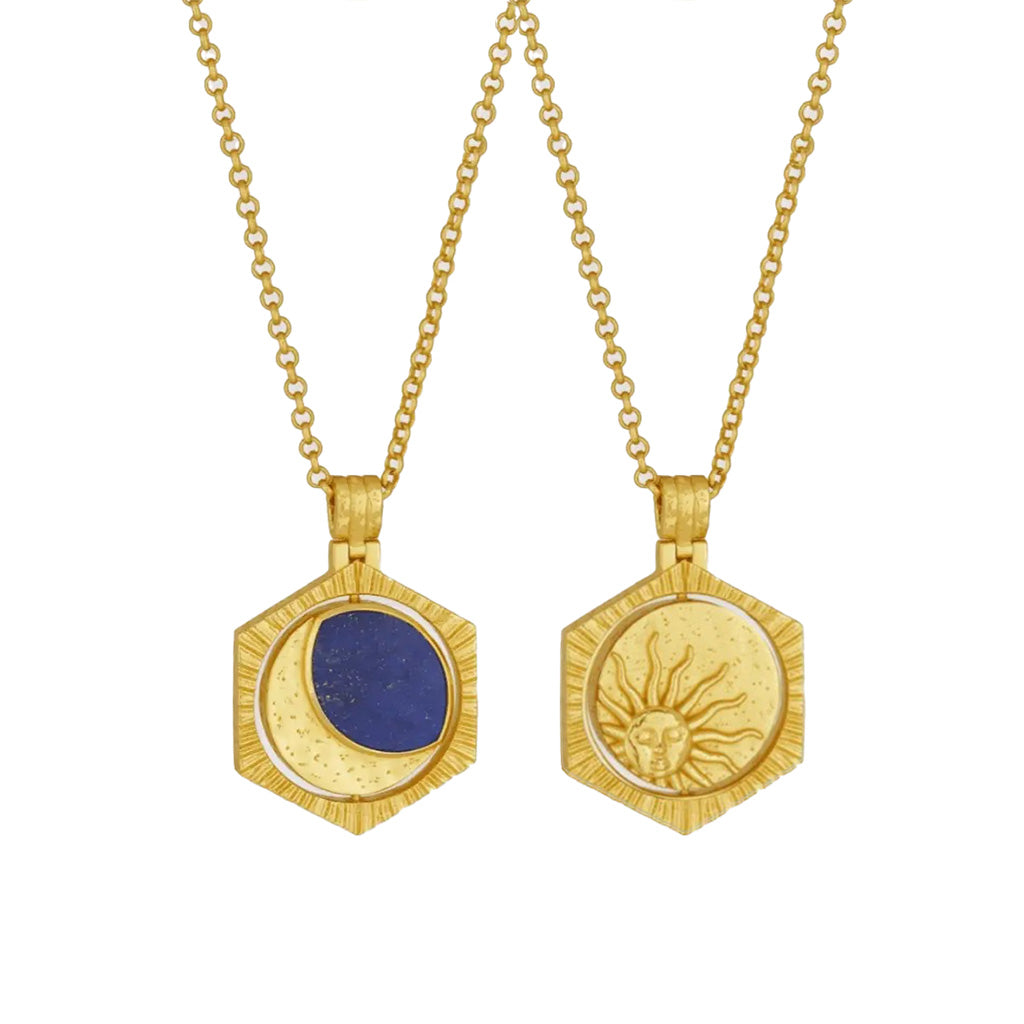 Gold plated hexagonal pendant necklaces showing rotating pendant side by side against a plain white background. The left pendant features a deep blue lapis inset with a crescent moon motif, while the right pendant has a textured gold sun face design.