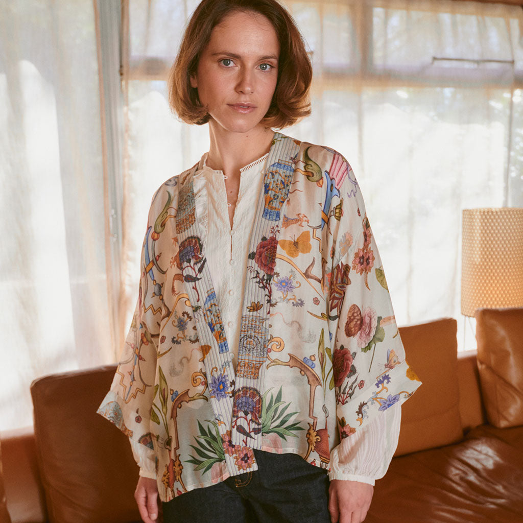 Model wearing Cornucopia Kimono in front of window and sofa