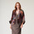 Colourful patterned wool kimono jacket on a hanger against a white background