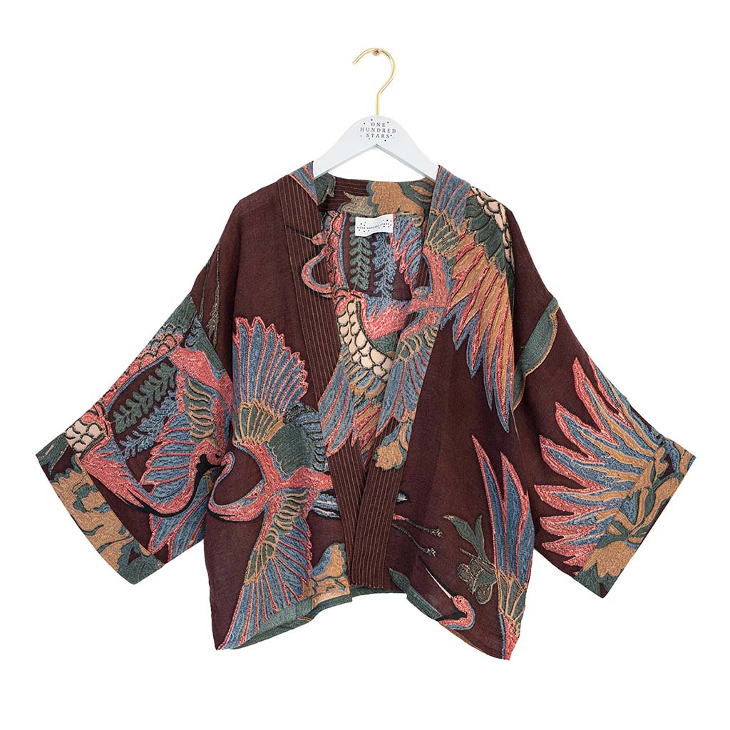 Colourful patterned wool kimono jacket on a hanger against a white background
