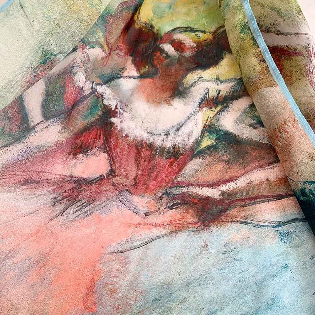 Close up of silk scarf featuring degas Ballerina painting of a figure in a dynamic pose
