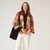 Colourful kimono-style garment on a hanger against a white background