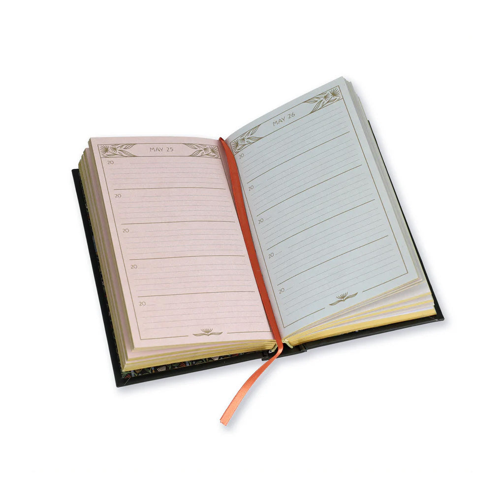 A Floral One Line a Day Book open on May 25th and May 26th. The left page is pink while the right hand page is blue and there is a red ribbon place keeper trailing down the centre. Each page is divided into 5 sections with a place to write the year at the start followed by blank lines to record your thoughts. 