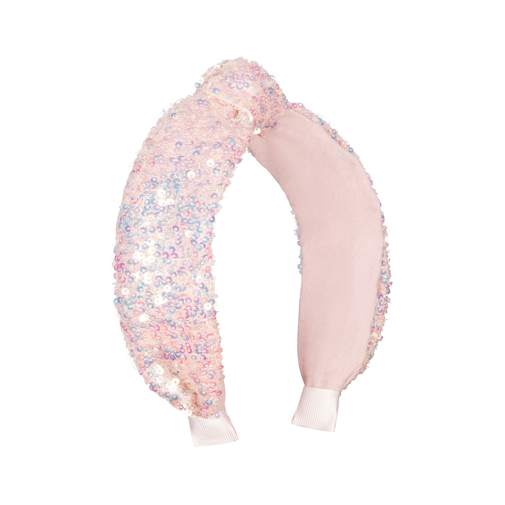 A kids Sequin Knotted Headband against a white background. The headband is pink and covered in luminescent sequins. There is a twisted knot at the top of the headband. 
