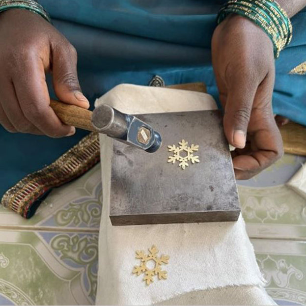 Artisan making Nutcracker Snowflake Earrings