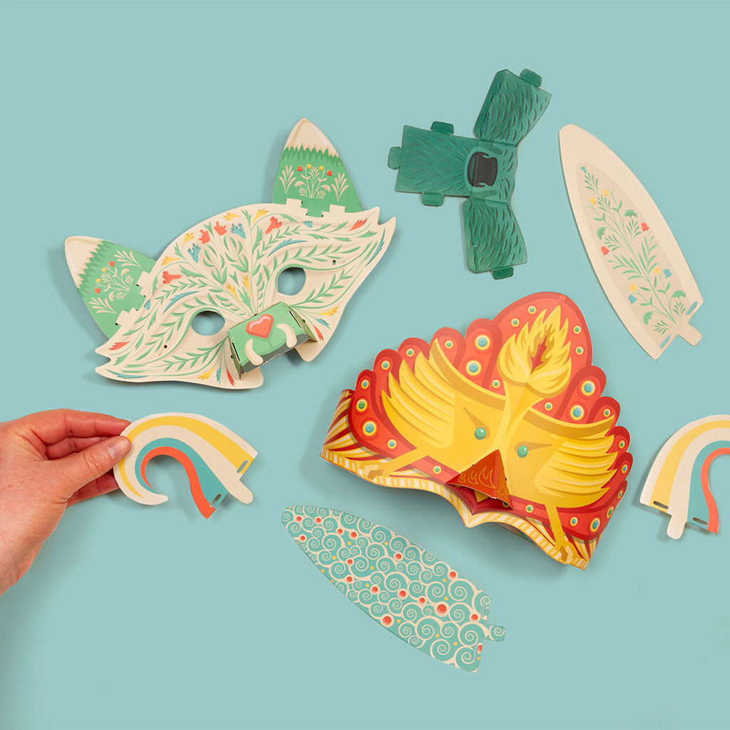 Colourful paper masks and attachments on a light blue background