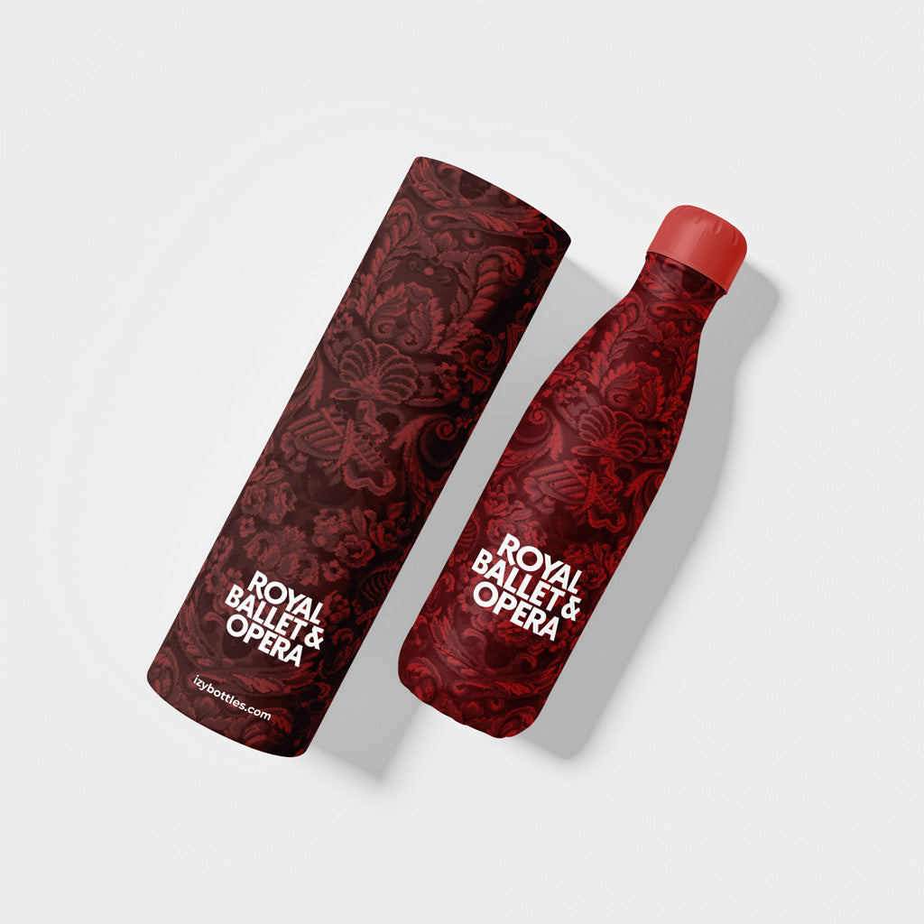 Red carpet patterned bottle and box with 'Royal Ballet & Opera' text on a white background