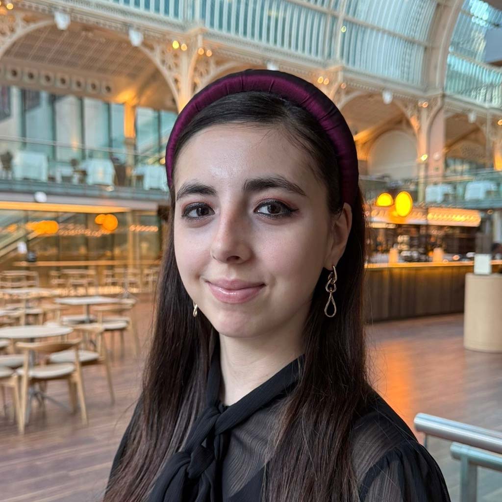 model wears a purple costume fabric padded headband in the Paul Hamlyn Hall at the Royal Opera House