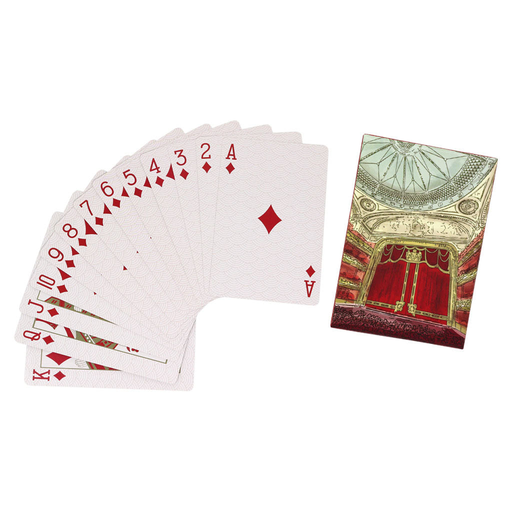 A set of Royal Ballet and Opera Auditorium Playing Cards. The box is open with the lid resting on the open box. The side of the lid and box are red with a geometric gold wave pattern. On the left side of the lid "Playing Cards" is written in gold. The top of the lid shows a painted style image of the Royal Ballet and Opera auditorium including the red and gold curtains and ornate blue domed ceiling. The inside of the box is obscured by the lid but we can see that the cards inside bear the same design. 