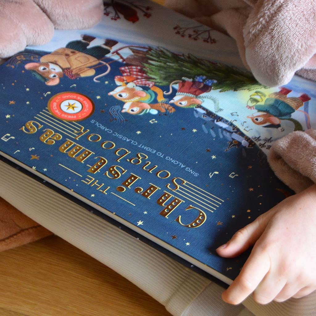 close up of a child reading the Christmas songbook