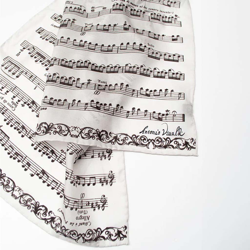 White scarf with black musical notes and text on a white background