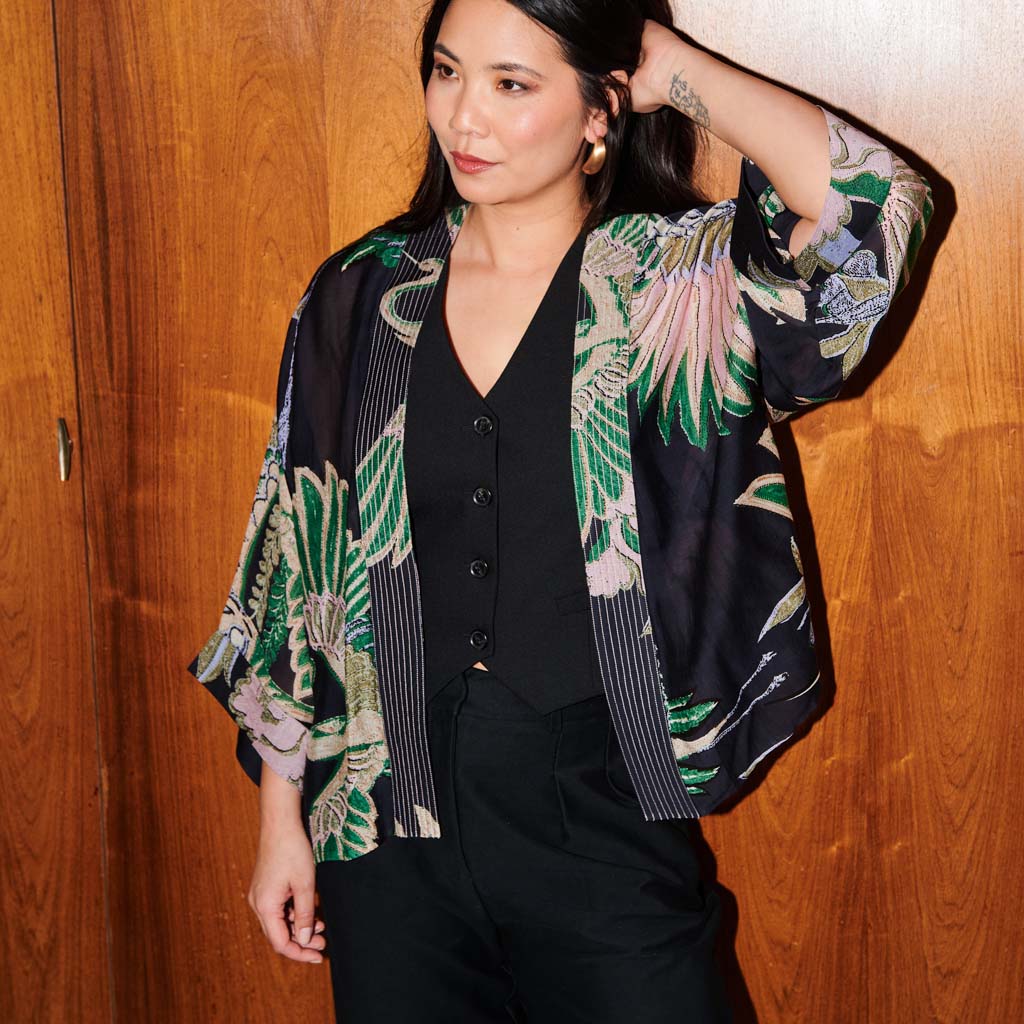 Black and green kimono style jacket on a white background