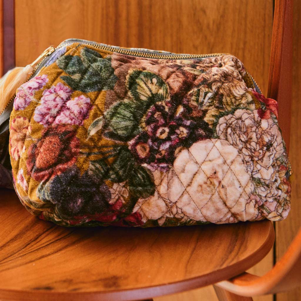 Gold Velvet floral themed pouch with a zipper and tassel on a white background