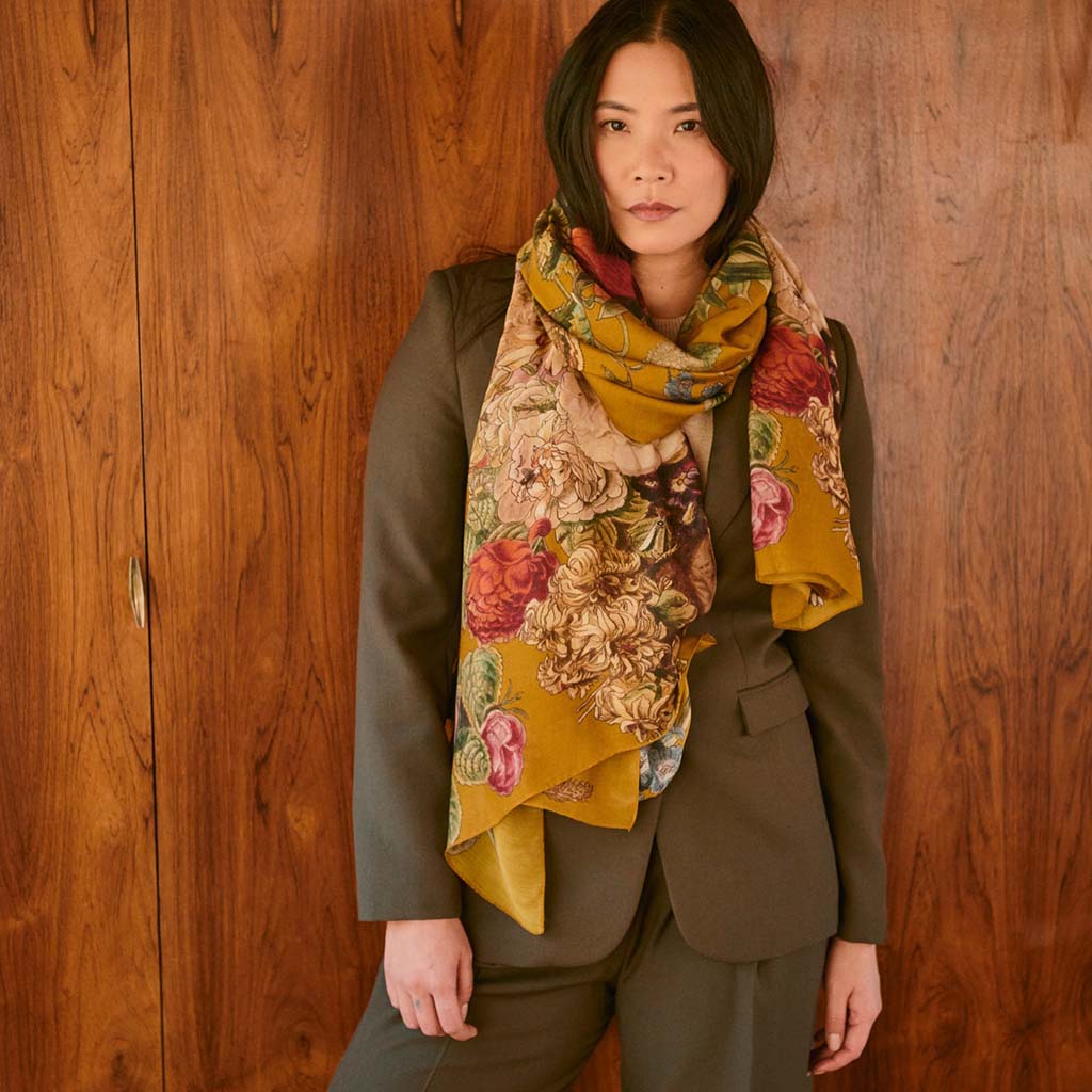 Gold scarf with colourful floral design on a white background