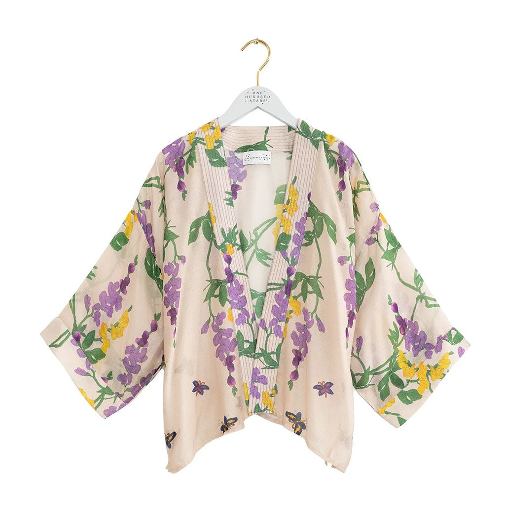 Floral-patterned kimono style lightweight jacket on a hanger with a white background