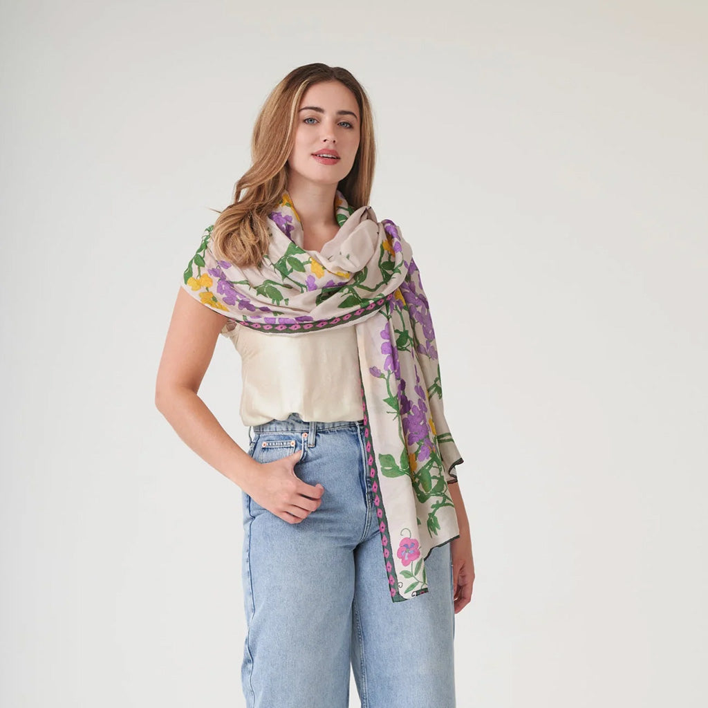 Woman wearing a floral scarf on a cream background