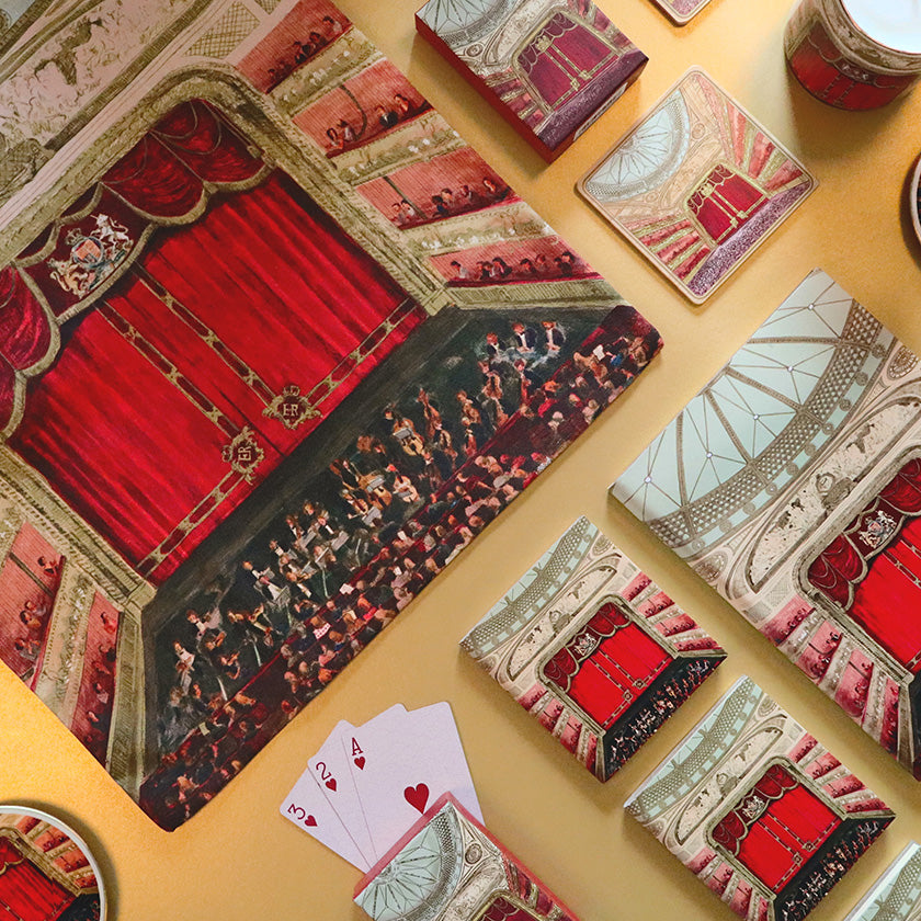 Auditorium Tote, Playing cards, notebooks and candle on a yellow surface