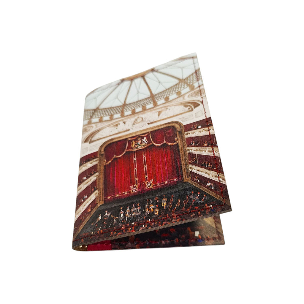 A leather card holder featuring a printed illustration of the auditorium at the royal opera house with red velvet curtains, balconies, and an orchestra, shown on a plain white background.