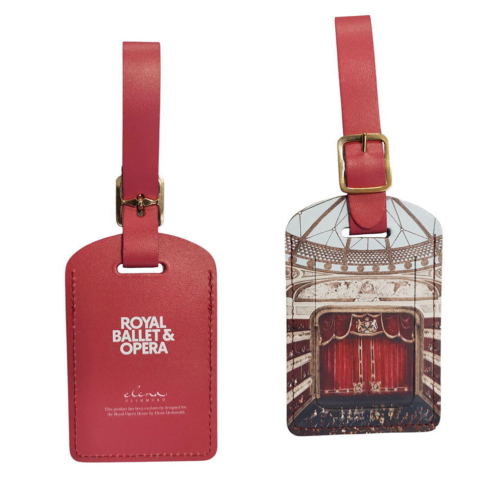 Two leather luggage tags on a white background, one shows a plain back view with white 'ROYAL BALLET &amp; OPERA' and 'Elena Deshmukh' text and the other printed with a ballet stage interior illustration. Both have gold-tone buckles and straps.