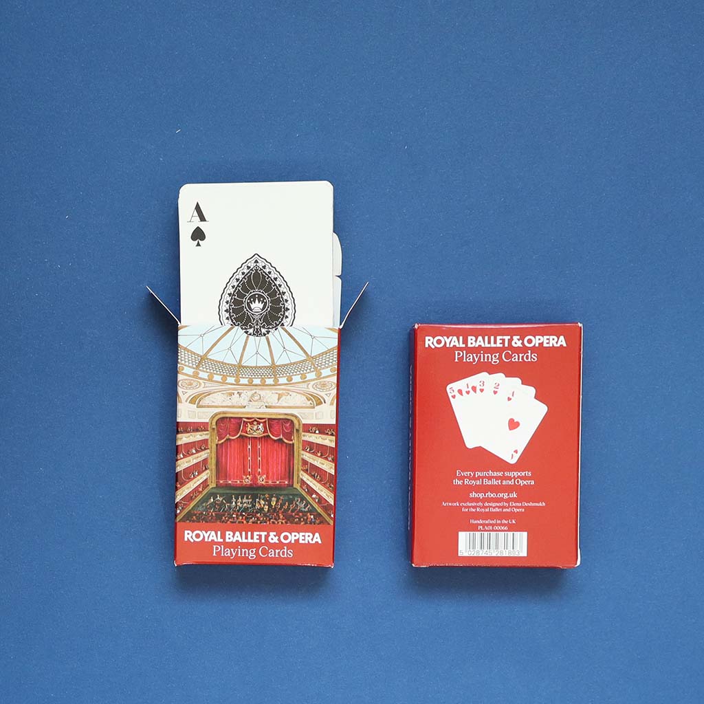 A fan of playing cards on a white background, showing the back design with an interior view of the Royal Opera House Auditorium in red curtains and beige architectural details, alongside an Ace of Spades card.