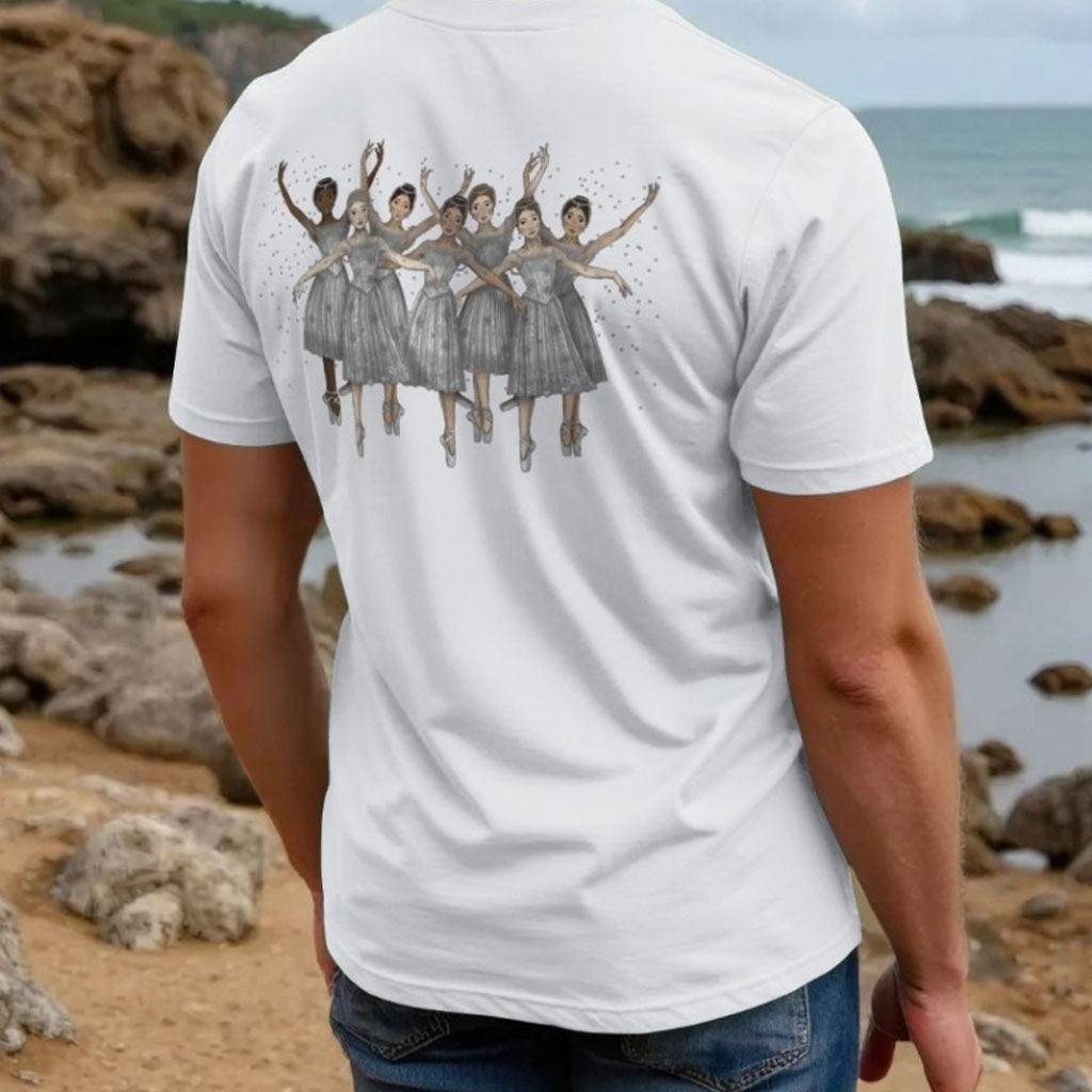 Person wearing a white t-shirt with a sugar plum fairy illustration on the back, standing on a rocky beach.