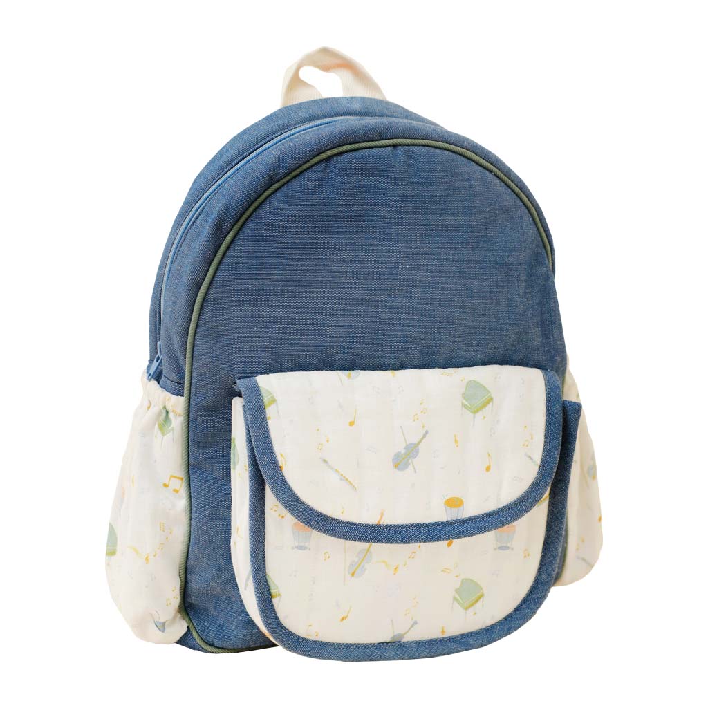Blue denim backpack with a patterned musical instrument pocket on a white background
