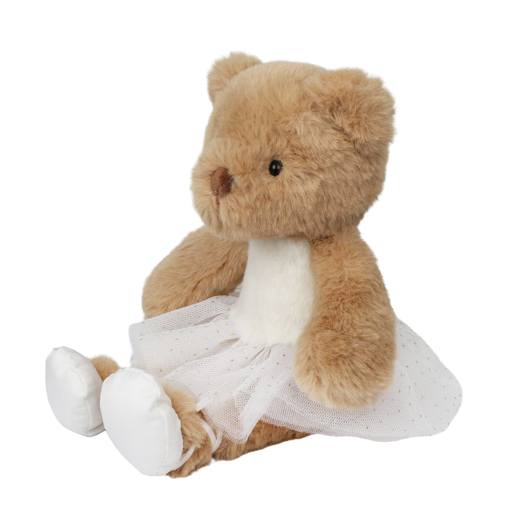 Plush teddy bear in a white tutu dress sitting down on a white background