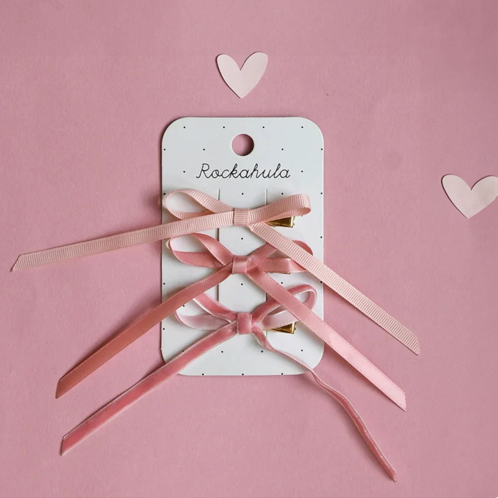 Pink ribbons clips on a Rockahula branded card with hearts on a pink background
