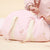 Pink ballerina duffel bag with cream handles on a white background