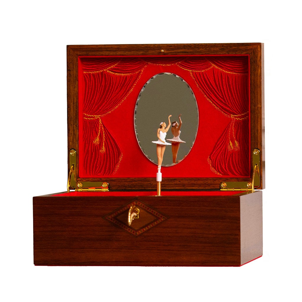 Wooden musical jewellery box with a mirror and two interchangable ballerina figurines on a red background