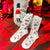 White socks with ballet-themed designs on a white background