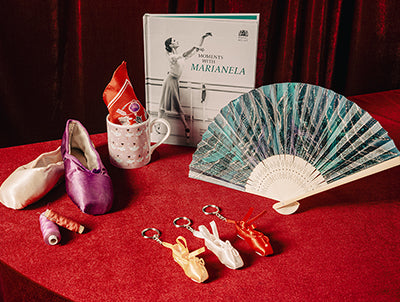 A selection of gifts for ballet fans on red velvet at the Royal Ballet and Opera