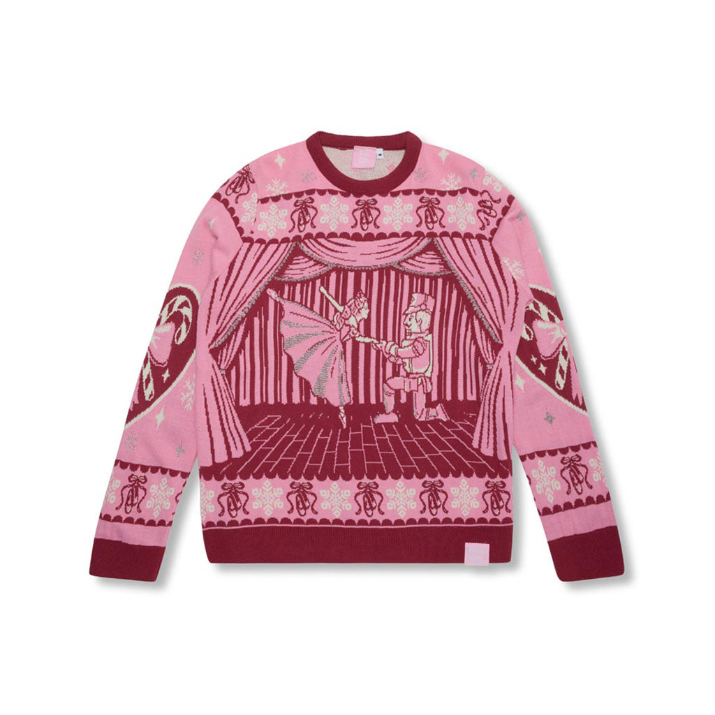 A pink Barbie Royal Ballet Christmas Jumper with a dark pink graphic of a Clara and the Nutcracker on a stage, featuring patterned cuffs and hem.