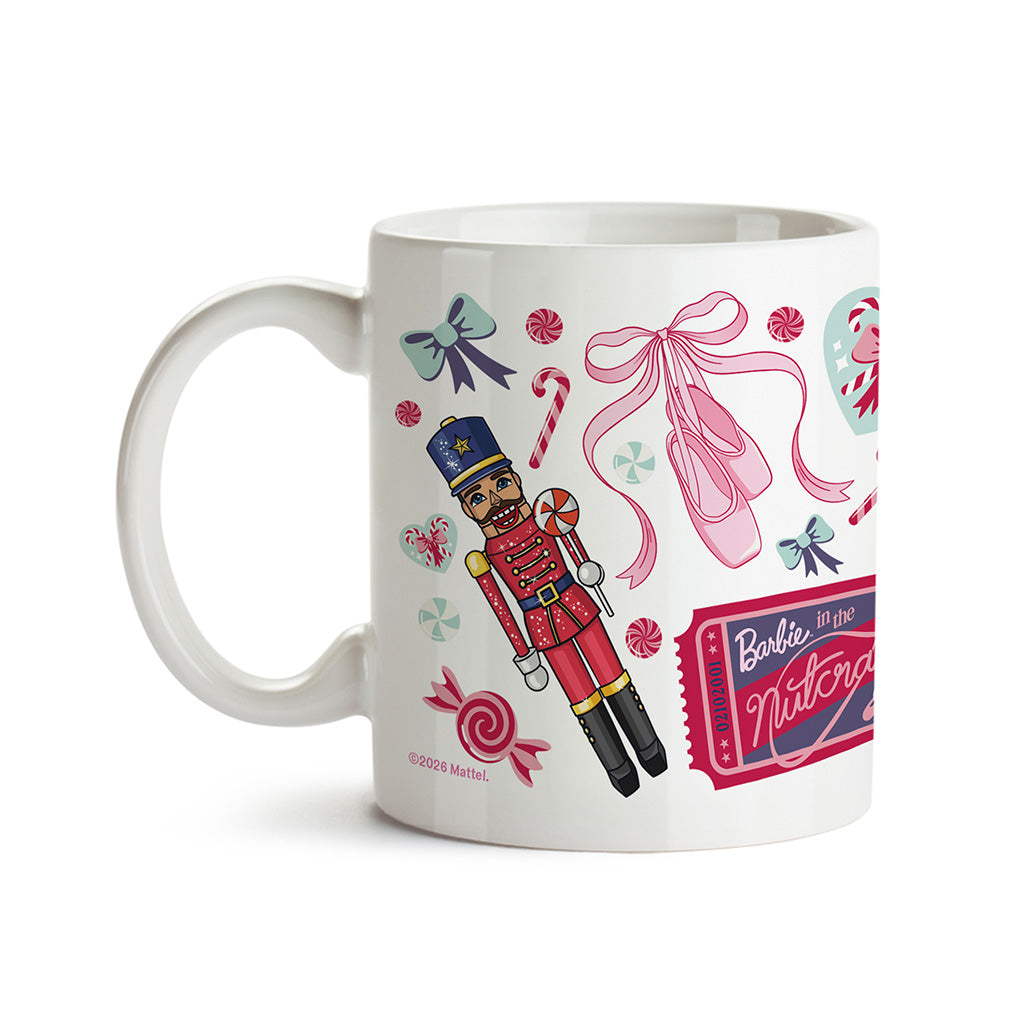 A white ceramic mug featuring a colourful 'Barbie in the Nutcracker' illustration with a nutcracker soldier, pink ribbon, ballet shoes, candy canes, bows, and a ticket graphic.