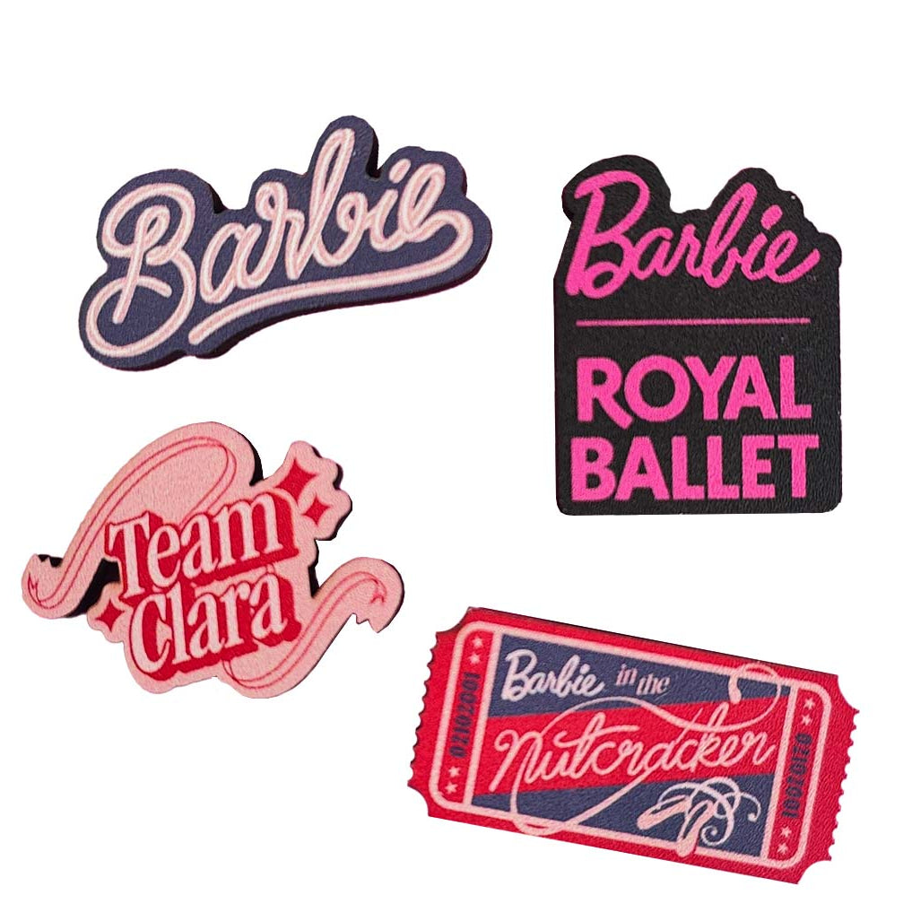 Set of 4 Barbie x RBO wooden pin badges on a white background