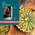 Book cover of 'The Weekend Cook' by Angela Hartnett with a aspargus tart background and the chef on a teal book cover