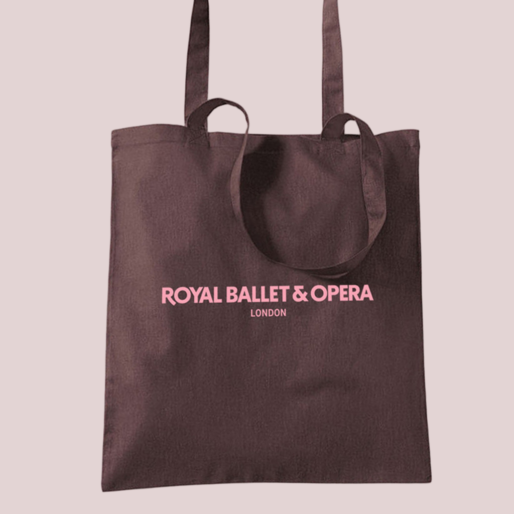 Brown tote bag with 'Royal Ballet & Opera London' in pink text on a white background