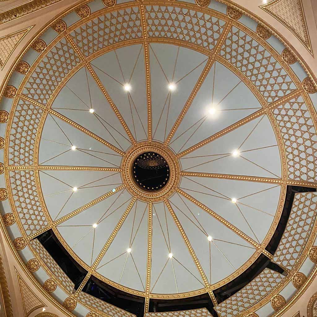 Pin badge featuring the auditorium ceiling in blue and gold