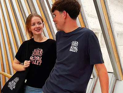 Two models on the bridge of aspiration in Royal Ballet tshirts, one navy with white logo, one black with rose gold logo