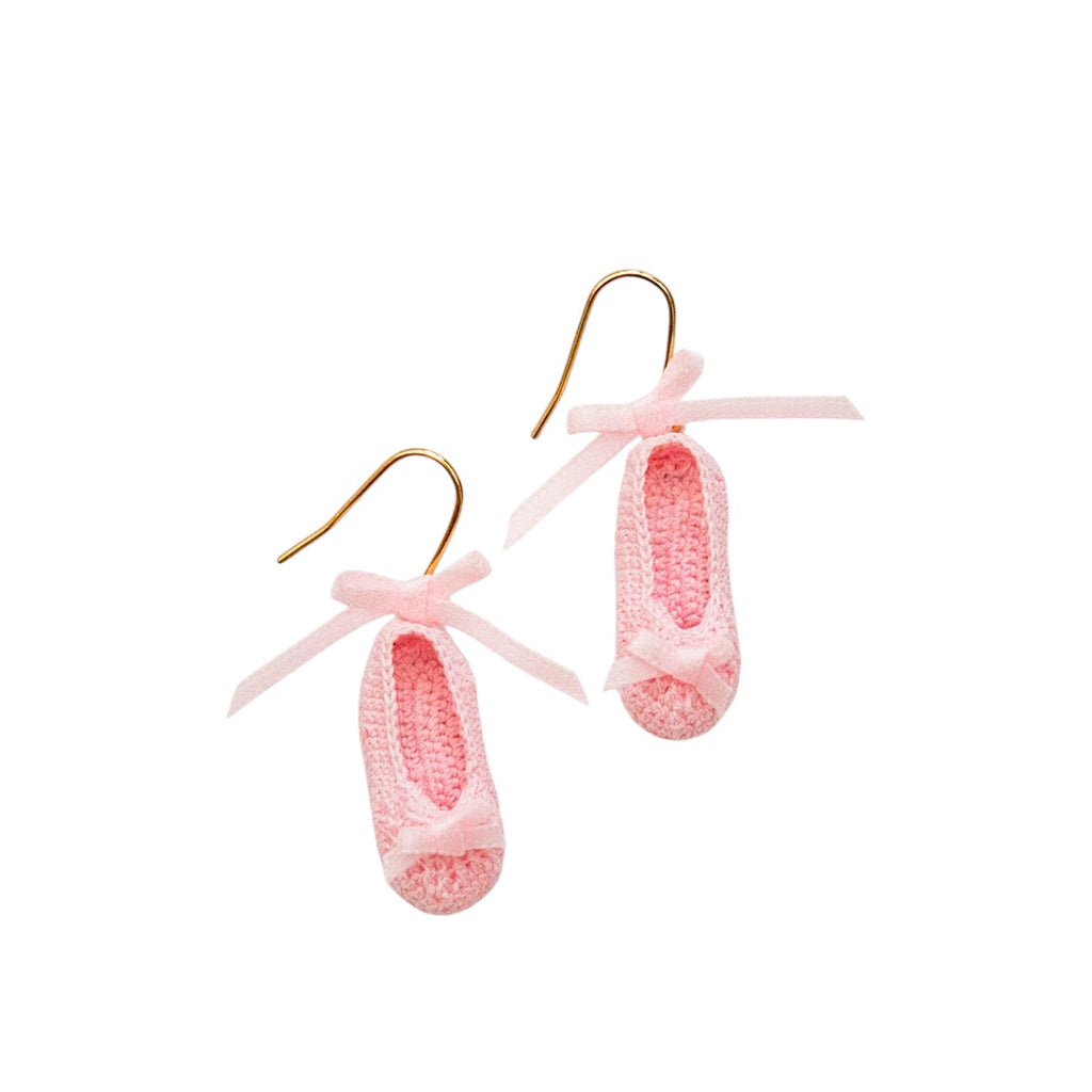 Pink mini crochet ballet shoes earrings with ribbons on a white background